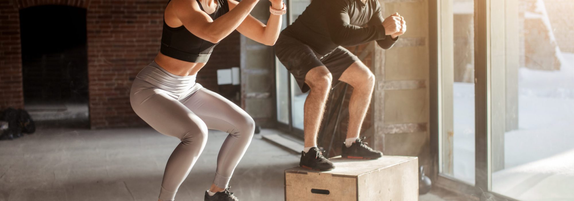 Handsome active caucasian couple, happy as family, successful as partners, determined as sports people, engaged in crossfit training.